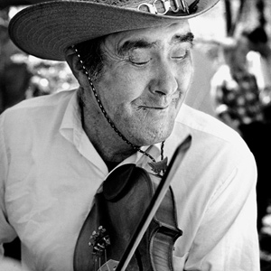 Jesse Ray - known as Lost John - wearing a spiffy cowboy hat playing old time fiddle