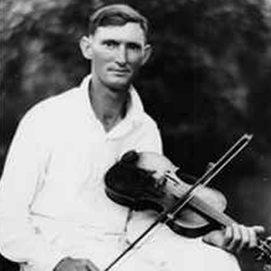 Portrait of Hiram Stampler with his fiddle in a neat white outfit